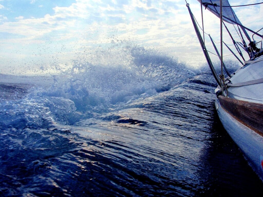 Sailing Boat in Waves at Sea