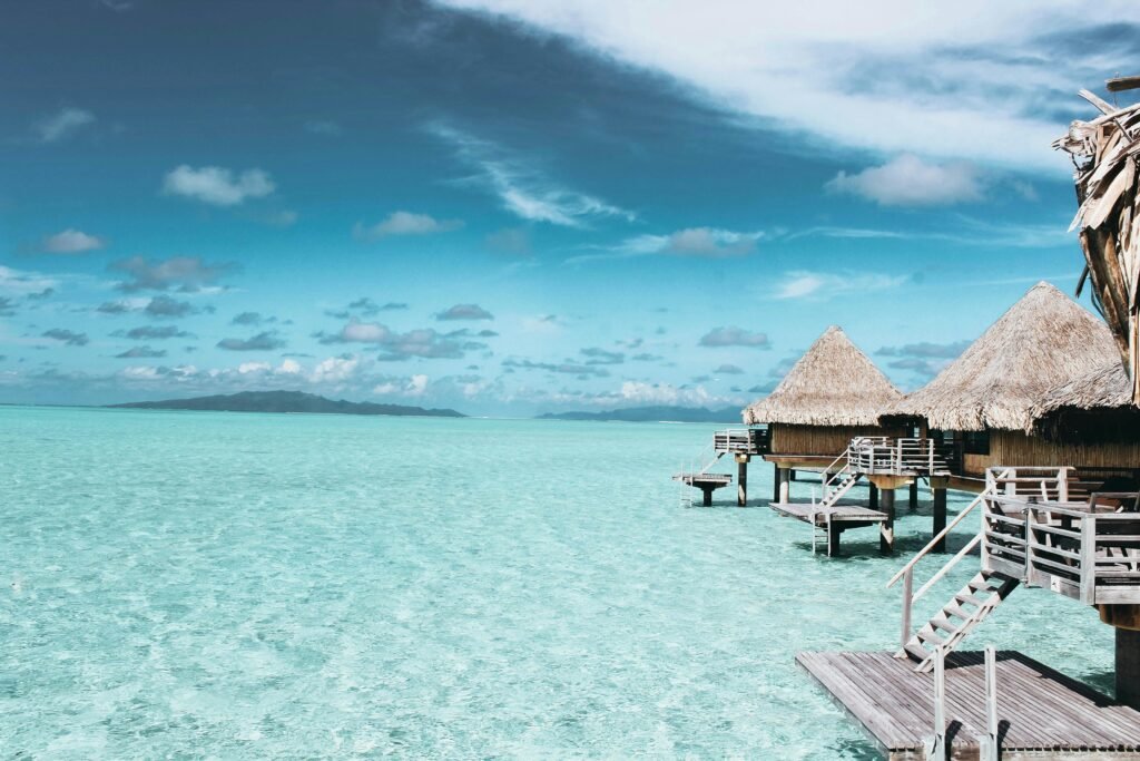 Overwater bungalows on a crystal-clear turquoise sea in French Polynesia.